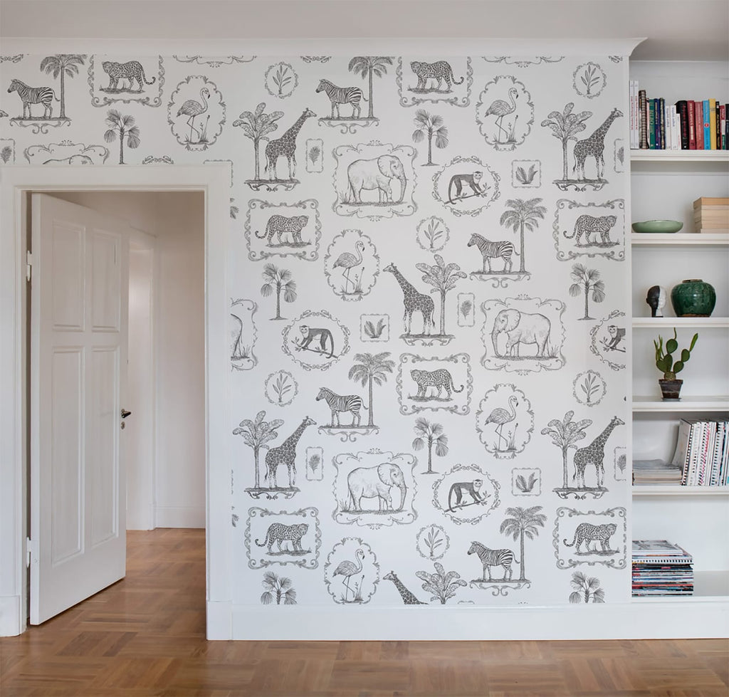 Animal Kingdom, Black & White Pattern Wallpaper featured on a wall of a room with a bookshelf seen with the wooden flooring 