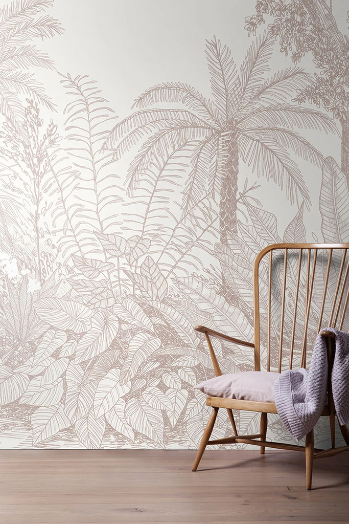 Ara's Jungle, Tropical Mural Wallpaper in Nude featured in a room with a wooden chair with ash purple blanket on a wooden flooring