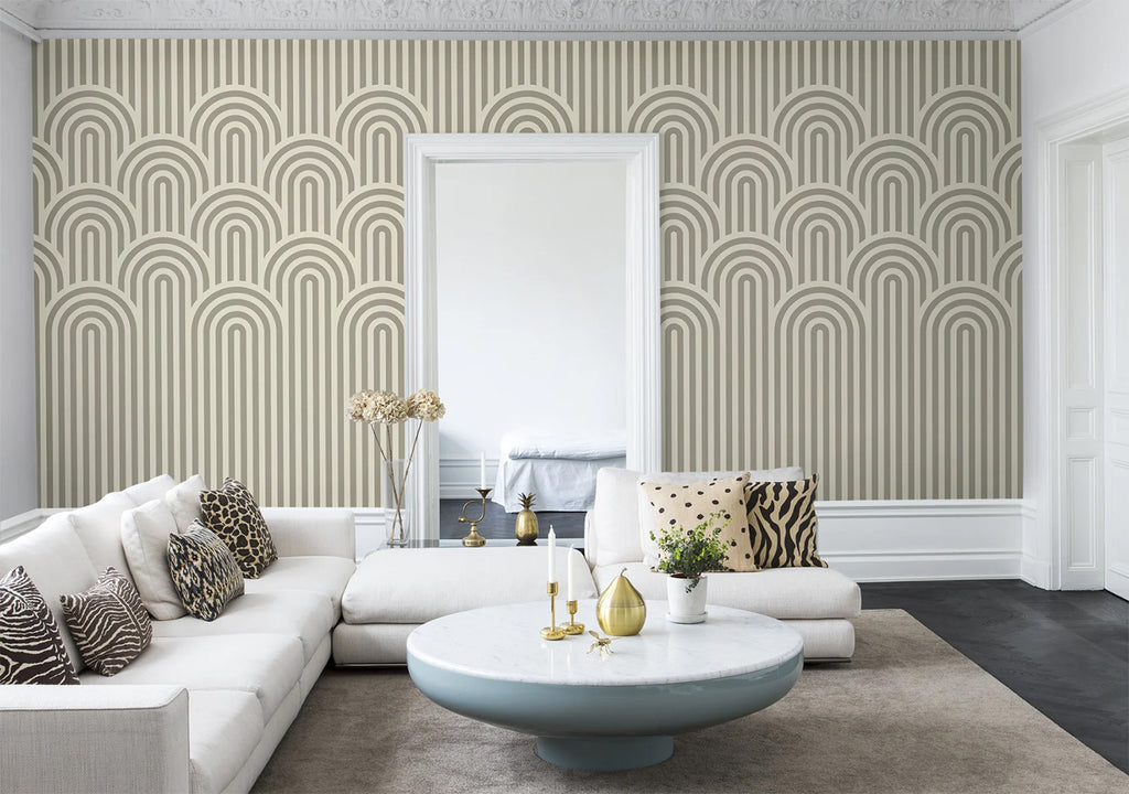 Arch Hills, Geometric Wallpaper in grey featured in wall of a living area with sofa and multi designed pillows and round table in tha middle