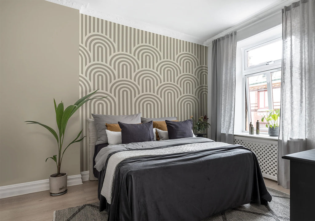 Arch Hills, Geometric Wallpaper in grey featured in wall of a natural-lit bedroom with a bed with black sheets and multicolored pillows