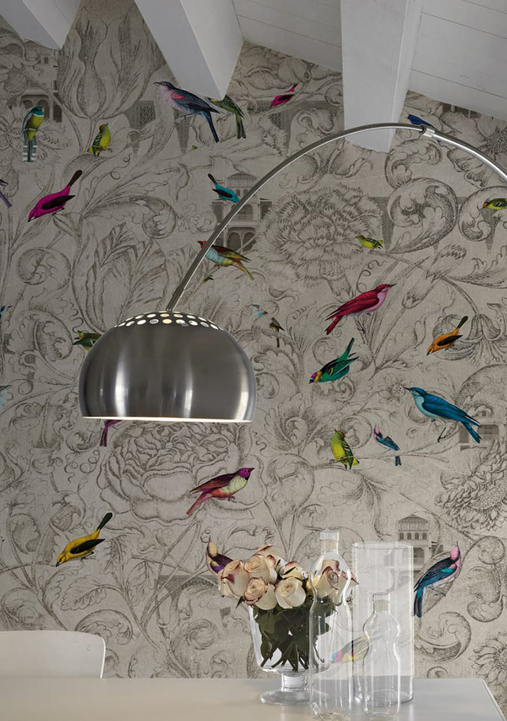 Birds of Paradise, Mural Wallpaper featured on a wall of what looks like a dining area with white table that has plant vase, bottle, and a glass, an aluminium lamp can also be seen
