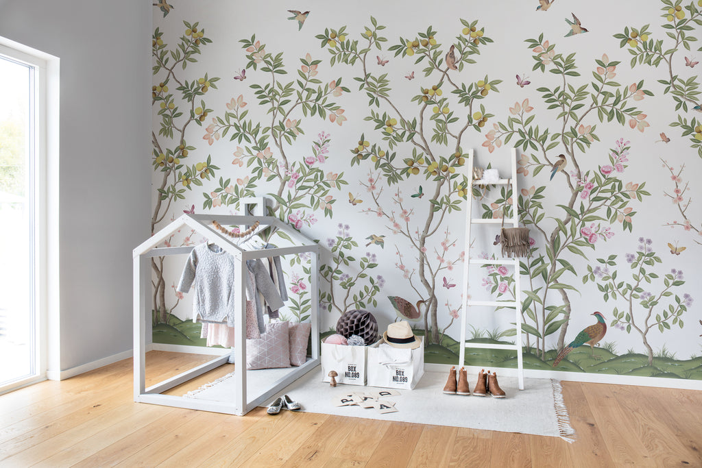 Chinoiserie Forest, Mural Wallpaper in green as seen in a kid’s playroom with several toys for kids