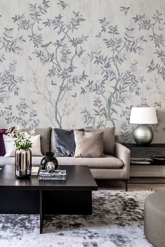 Chinoiserie Forest, Mural Wallpaper in Light Grey as seen in a living area with sofa, pillow, coffee table and rug