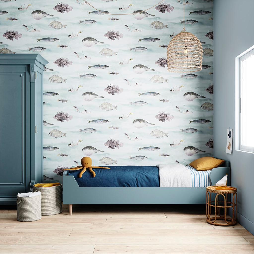 Classic Fish, Pattern Wallpaper in Blue adorns a serene room with a cozy bed, woven light fixture, wooden floor, storage baskets, and a plant on a stool