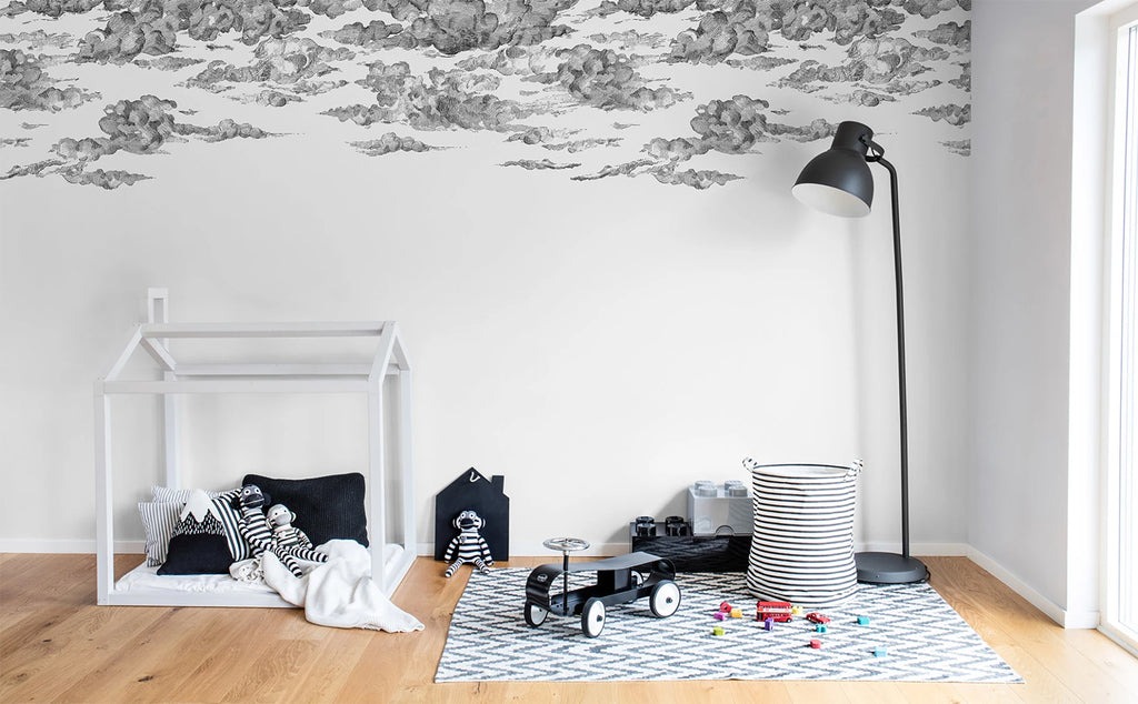 Cotton Skies, Mural Wallpaper in Black featured on a wall of a kid's room with wooden house frame and toys scattered around it