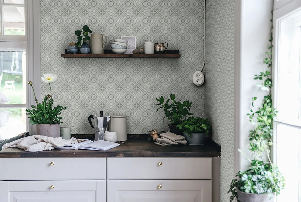 Edvin Rhombus Patterned Wallpaper in sage featured on a wall of a kitchen with a wooden countertop 