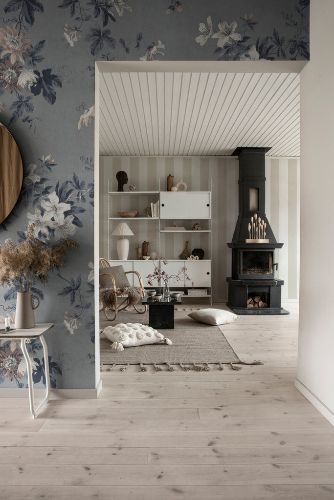 Faded Passion, Floral Wallpaper in blue featured featured on a wall of a hallway with a living area seen from its doorway