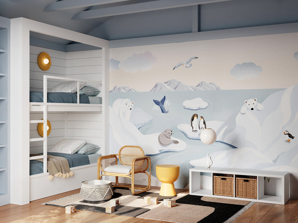 A child’s room with modern decor, featuring a rattan armchair, a bright yellow stool, and white open shelving filled with books and toys. The floor is wooden with a plush rug and scattered toys, creating a playful area. The room is adorned with a whimsical Frosty Friends at the Arctic, Animal Mural Wallpaper.