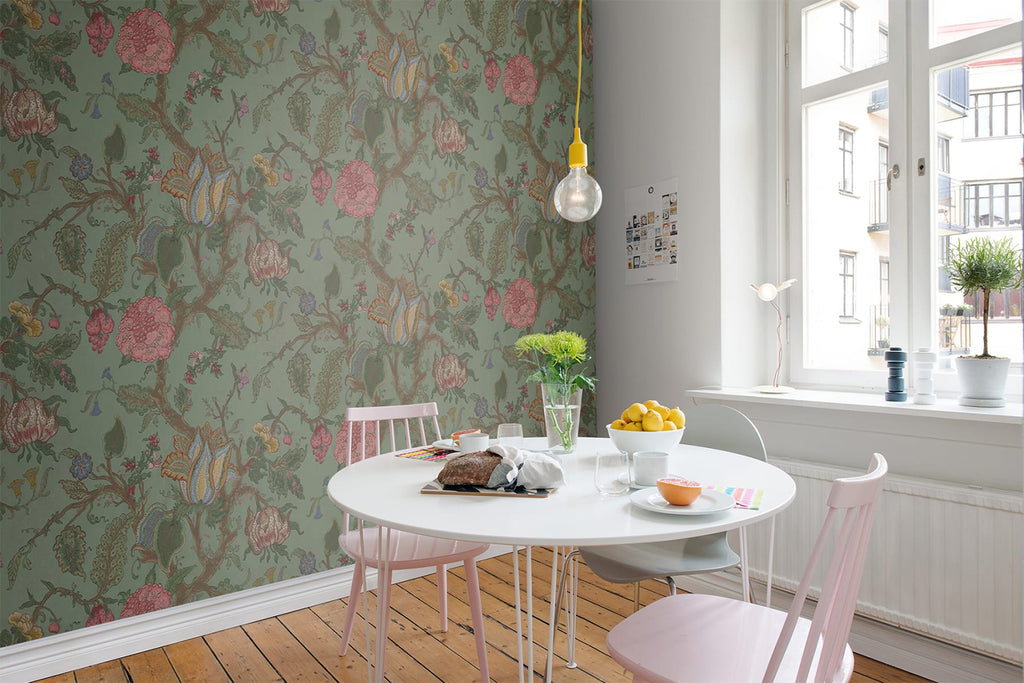 Growing Wilderness Floral, Wallpaper featured on a wall of a living area with green sofa and white round table