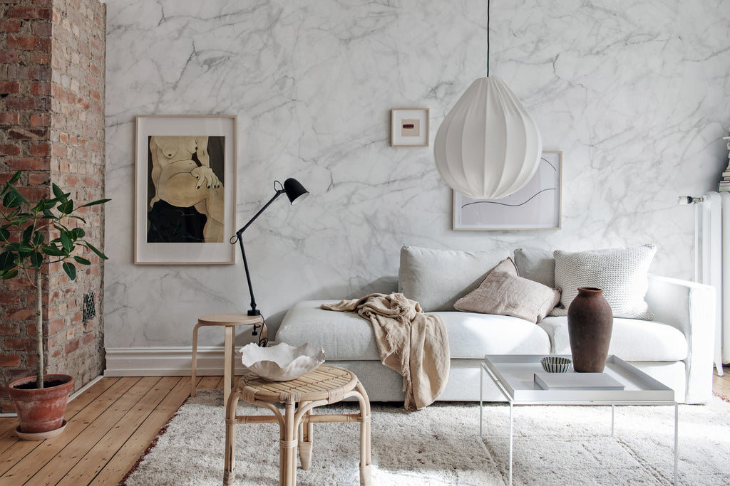 Marble Art, Texture Wallpaper featured on a wall of a living room with white sofas and pillows with transparent table and a rattan chair