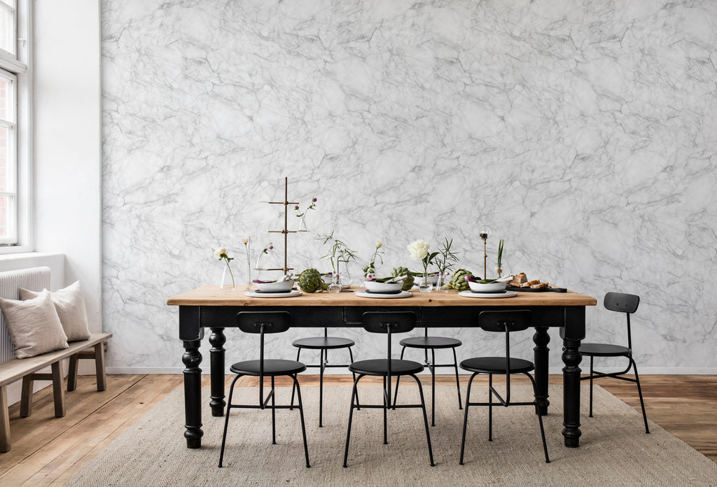 Noble Marble, Grey Wallpaper featured on a wall of a dining area with black chair and table with wooden base and black legs 