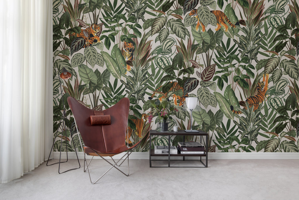 Playful Tiger, Pattern Wallpaper in sand colourway featured in a wall of a room with maroon chair and side tble