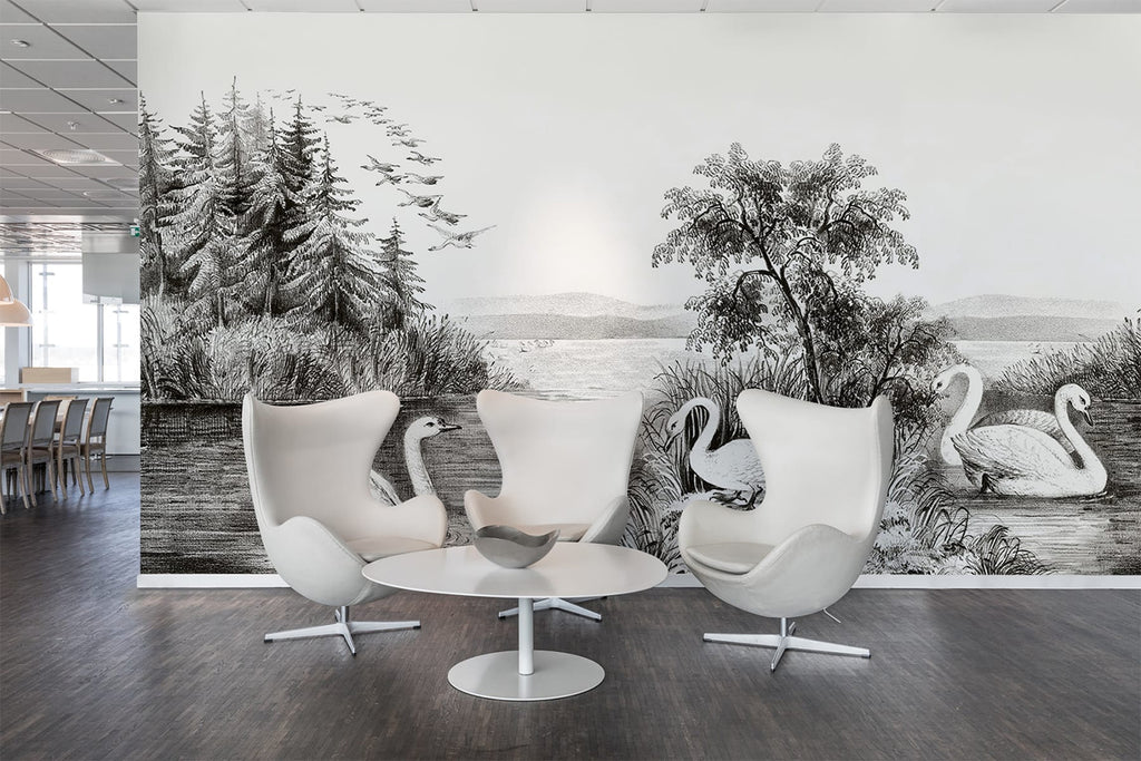 Swan Lake, Nature Mural Wallpaper in dark grey  as seen on the wall of am office with wooden flooring, and round table with modern white stools. 