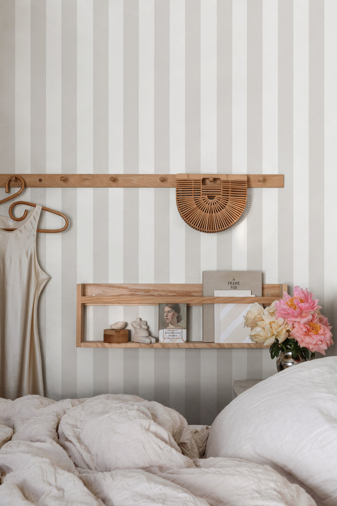 Teira Stripes, Wallpaper in Grey Featured on a wall of a bedroom with a bed with white sheets and pillows