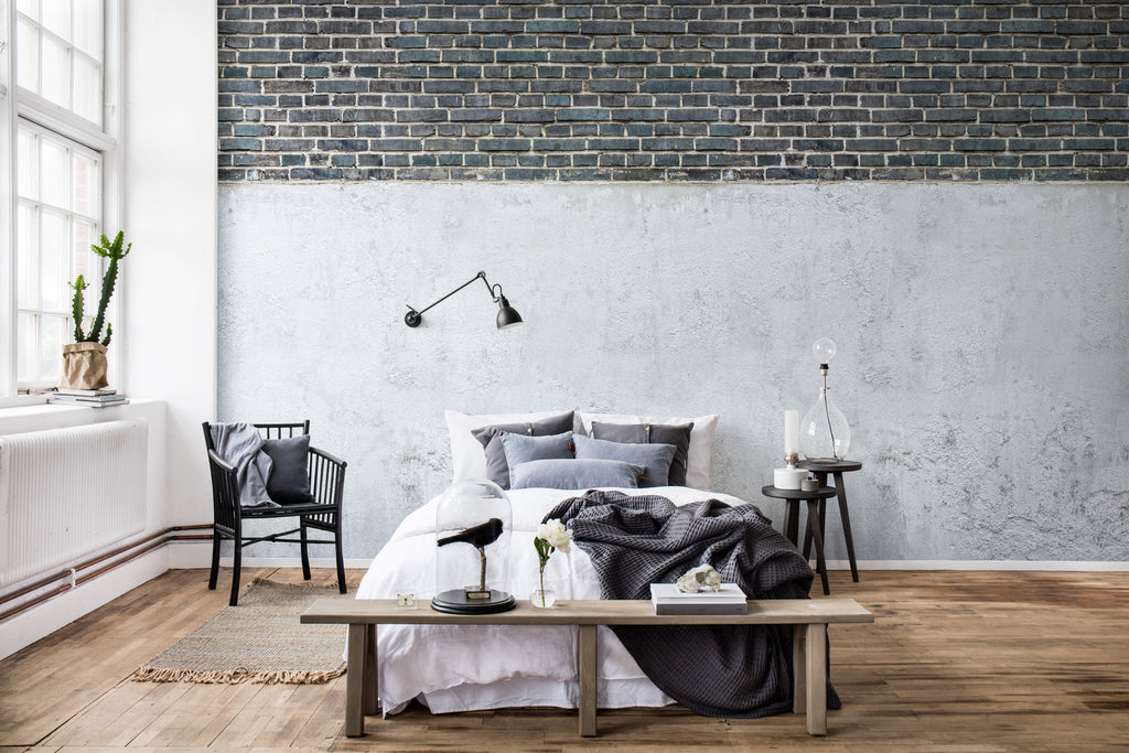 Top Brick Concrete Wall, Faux Texture Wallpaper featured on a wall of a bedroom with black, white, and grey pillows and sheets 