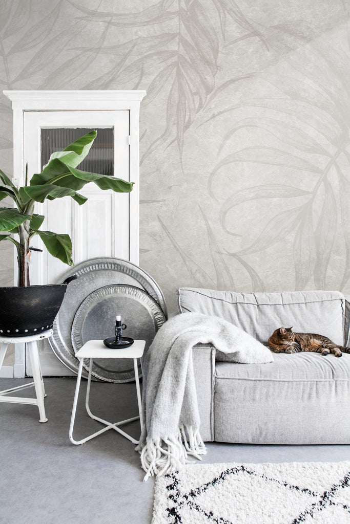 The Light Grey Terry Leaf Wallpaper elegantly decorates a wall in the living area, adding a touch of sophistication to the space.