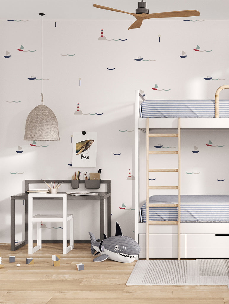 Little Sailors, Pattern Wallpaper in Blue/Grey applied in a kid's bedroom surrounded by well furnished wood furniture and toys.