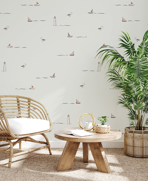 Mini Seafarer, Pattern Wallpaper in light grey, applied in a kid's wallpaper featured in a cozy living area with wooden furnishing and planters.  