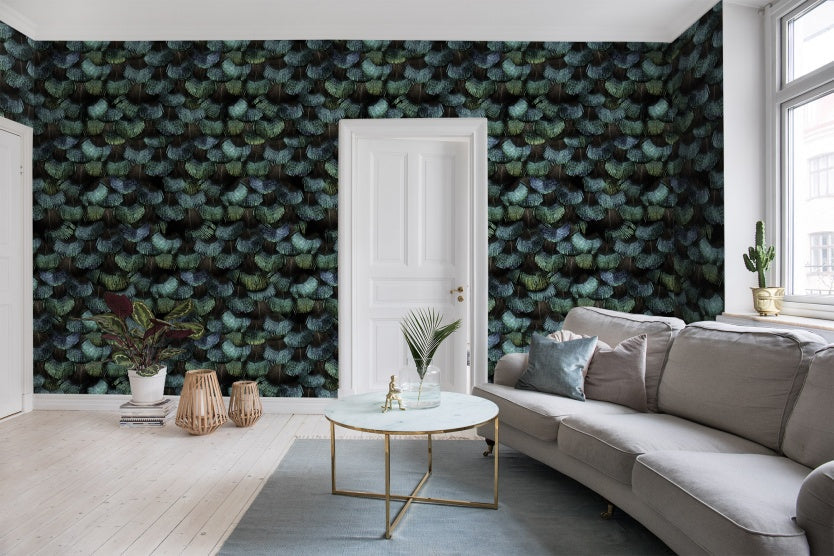 Living room area with grey sofa and a white round coffee table. Peacock plumage wallpaper applied to the walls.