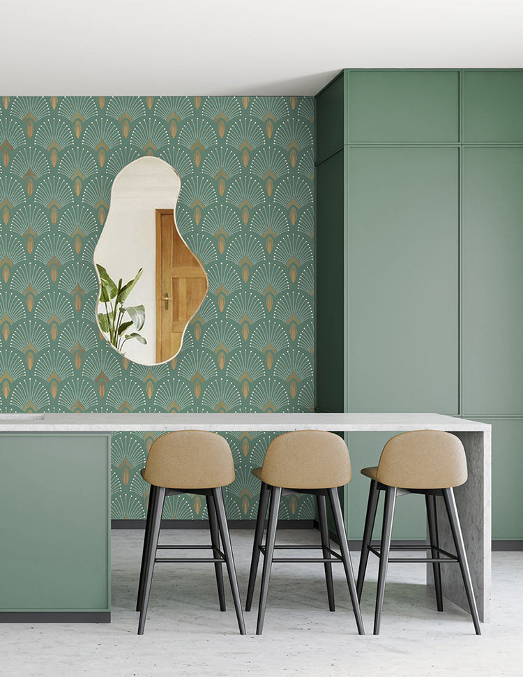 Modern room with 1920s Fan, Geometric Wallpaper in Emerald Green. Features a green cabinet, unique mirror reflecting a wooden door, and three beige stools at a grey countertop.