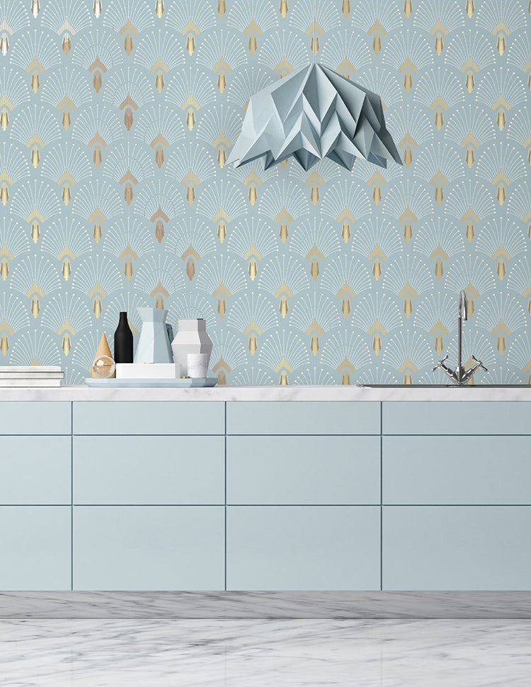 A modern kitchen with light blue cabinets and marble floor, adorned with elegant vases. A unique pendant light hangs above. The room features a 1920s Fan, Geometric Wallpaper in Light Blue.
