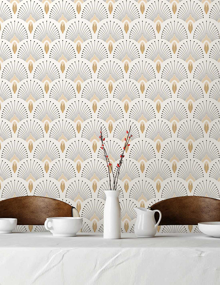 A cozy room adorned with 1920s Fan, Geometric Wallpaper in White. The room features a white table set with elegant tableware, a vase of red flowers, and two wooden chairs, creating a warm and inviting atmosphere.