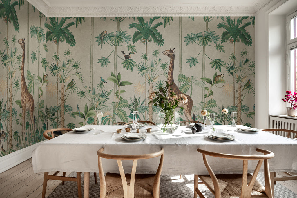 A Walk in the Jungle, Mural Wallpaper in white featured on a wall a dining room with a table that has white fabric on it and wooden chairs that matches its aesthetics