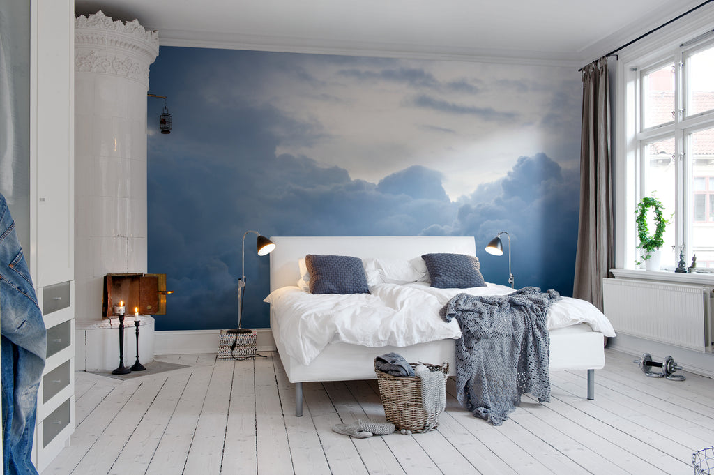 Above the Clouds, Sky Mural Wallpaper, featured on a wall of a comfortable bedroom with soft cushion and fabric