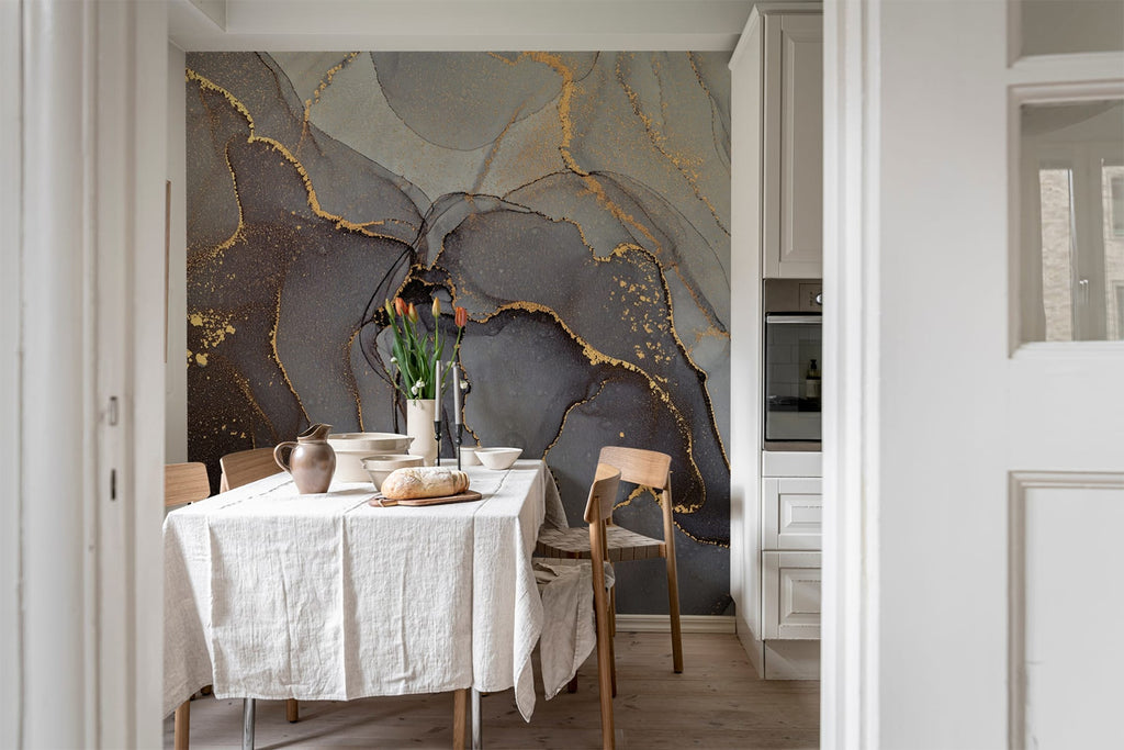 Agate Crystal Marble Texture Wallpaper in Onyx Black featured on the wall of a dining area, with a wooden table that has white table cloth, and has a bread, a picther, and a flower vase on top, along side with wooden chairs around the table. 