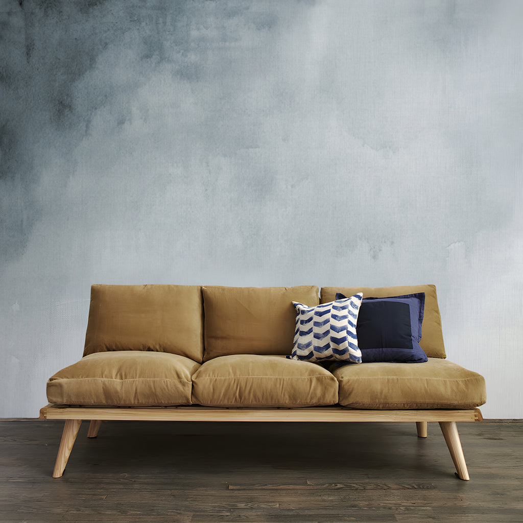 Aista, Ombre Watercolour Wallpaper in grey  featured in a room with wooden sofa and brown cushion