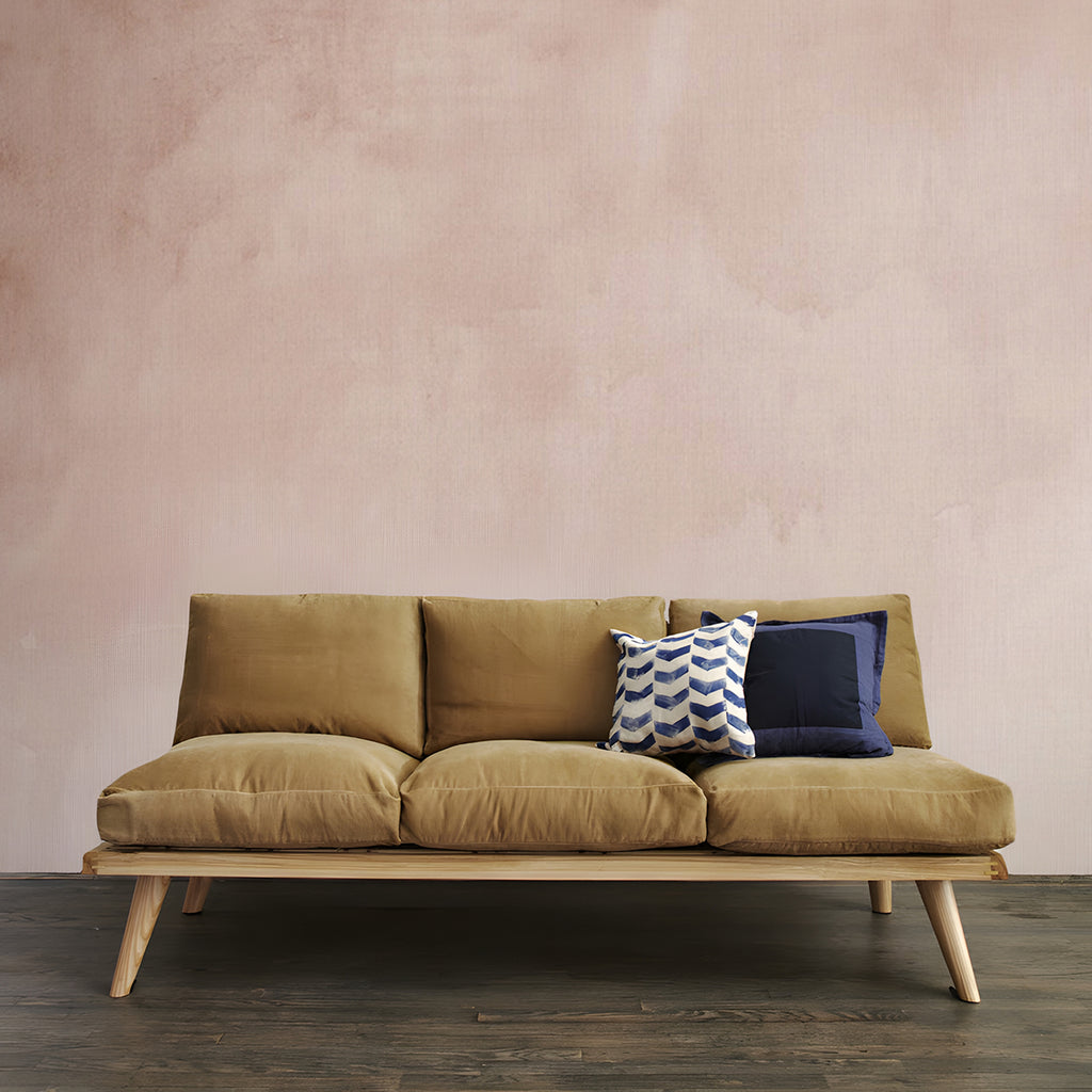 Aista, Ombre Watercolour Wallpaper in nude  featured in a room with wooden sofa and brown cushion