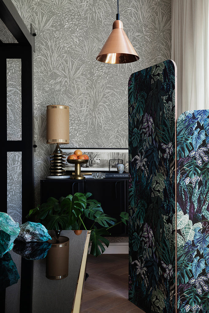 Amazon, Botanical Pattern Wallpaper  in Stratos Grey featured in a room with rattan chairs, pillows and magazines on the ground