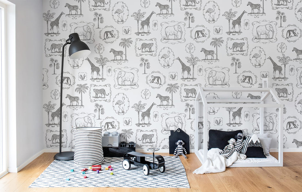 Animal Kingdom, Black & White Pattern Wallpaper featured on a wall of kid’s playroom with a wooden playhouse and patterned floor mat on a wooden flooring with scattered toys on the ground