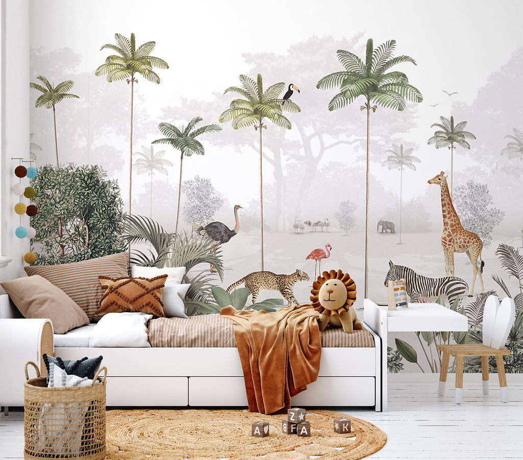 A serene room adorned with Animal Paradise Mural Wallpaper featuring tropical scenes—palm trees, giraffes, and flamingos. The minimalist decor includes a white sofa, brown pillows, a round rug, and a small wooden stool.