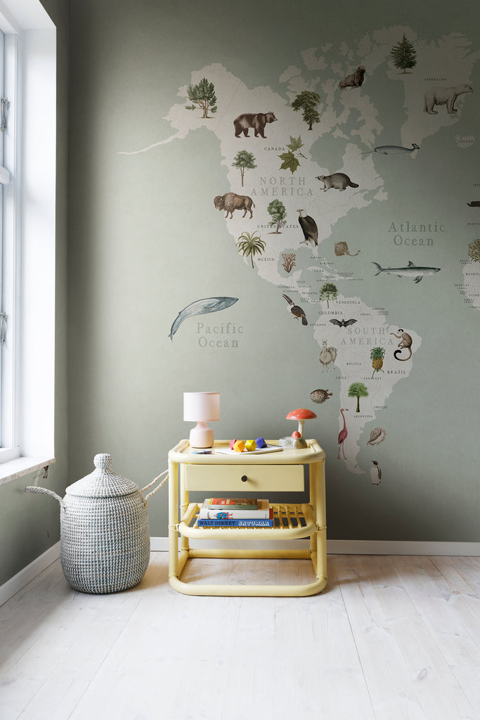 Animal World, World Map Mural Wallpaper in green featured in a kid’s room with mini cabinet and plastic toy jar