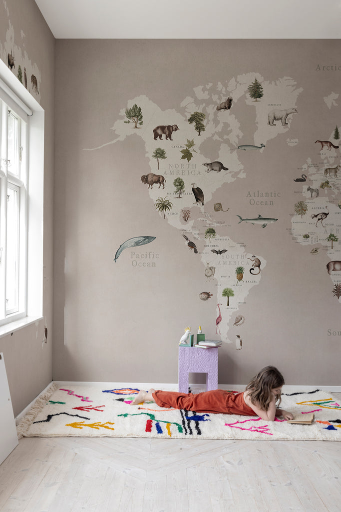 Animal World, World Map Mural Wallpaper in nude featured in a kid’s room with a children’s floor mat