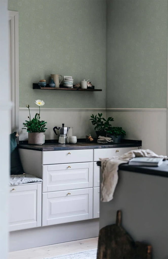 Anton, Floral Pattern Wallpaper in sage featured on a wall of a kitchen area with a granite countertop and several items on top of it
