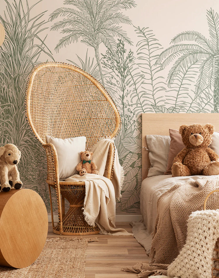 Ara’s Jungle, Tropical Mural Wallpaper in Green, showcased on a room wall. This room is tastefully furnished with a modern rattan chair and a bed, enhancing the tropical ambiance.