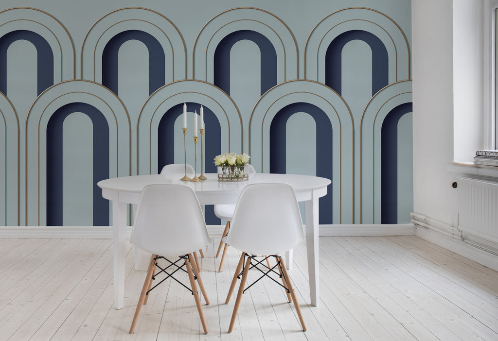 Arch Decor in Blue, Geometric Wallpaper featured on a wall of a dining area with white round table and chairs that matches it’s aesthetics