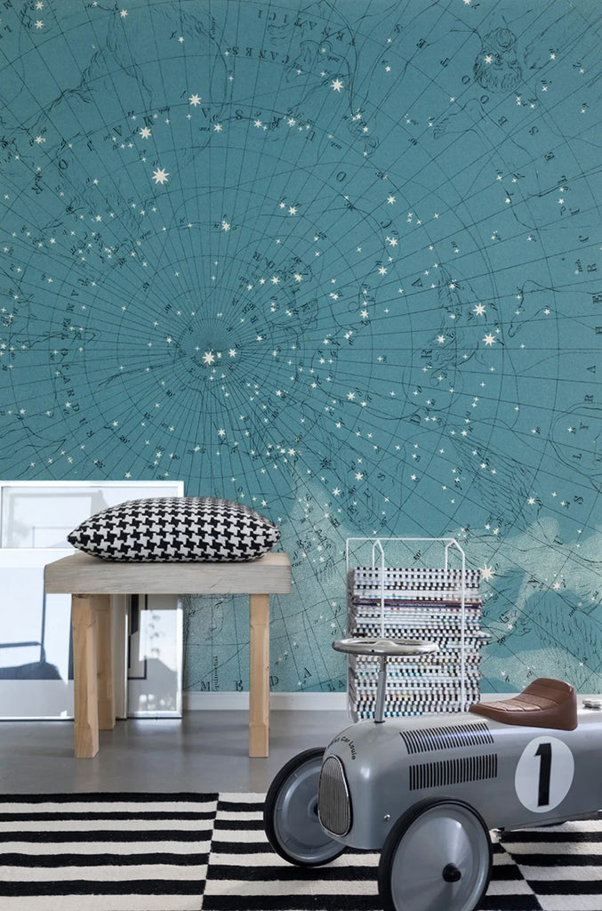 Atlas of Astronomy, Star Map Mural Wallpaper featured on a room of a kid’s playroom with a geometric floor mat and a toy car