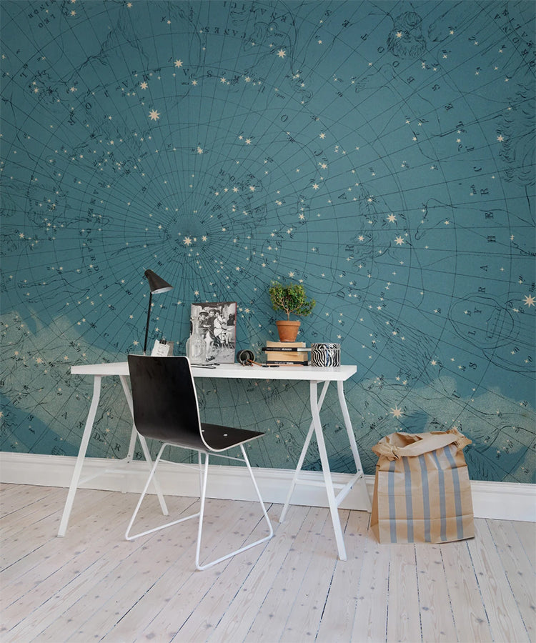 Atlas of Astronomy, Star Map Mural Wallpaper featured on the wall of a study room with wooden flooring with white table and black chair. 