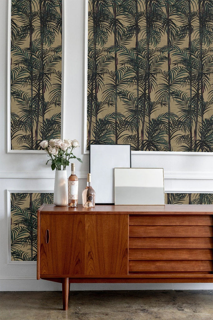 Bamboo, Tropical Pattern Wallpaper in Clay featured in a wall of a room with a wooden vintage sideboard with bottle, and vase on top
