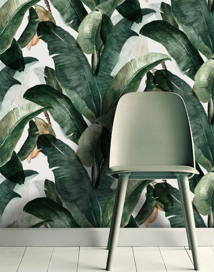 Banana Leaves, Tropical Pattern Wallpaper featured on a wall of a room with a green chair