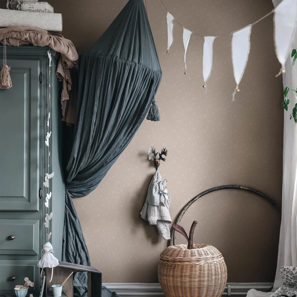 Bianca, Floral Pattern Wallpaper in Nude Featured on a wall of a room with green cabinet, and rattan basket