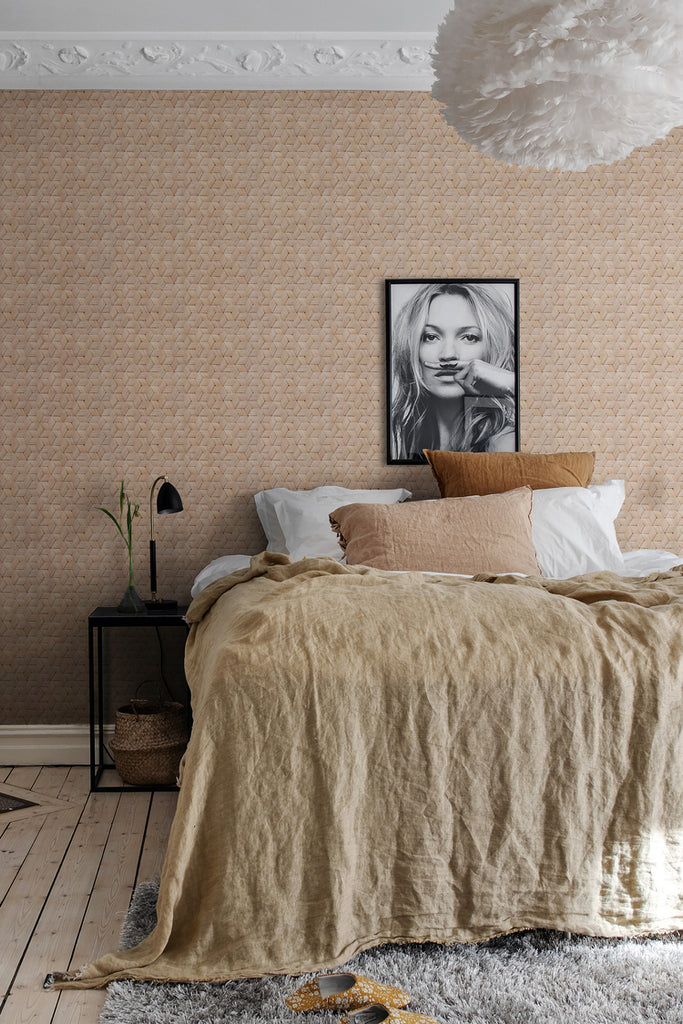 Birch Bark Braids, Pattern Wallpaper in brown colourway, featured on a wall of a bedroom with brown bed fabric and fluffy floor mat