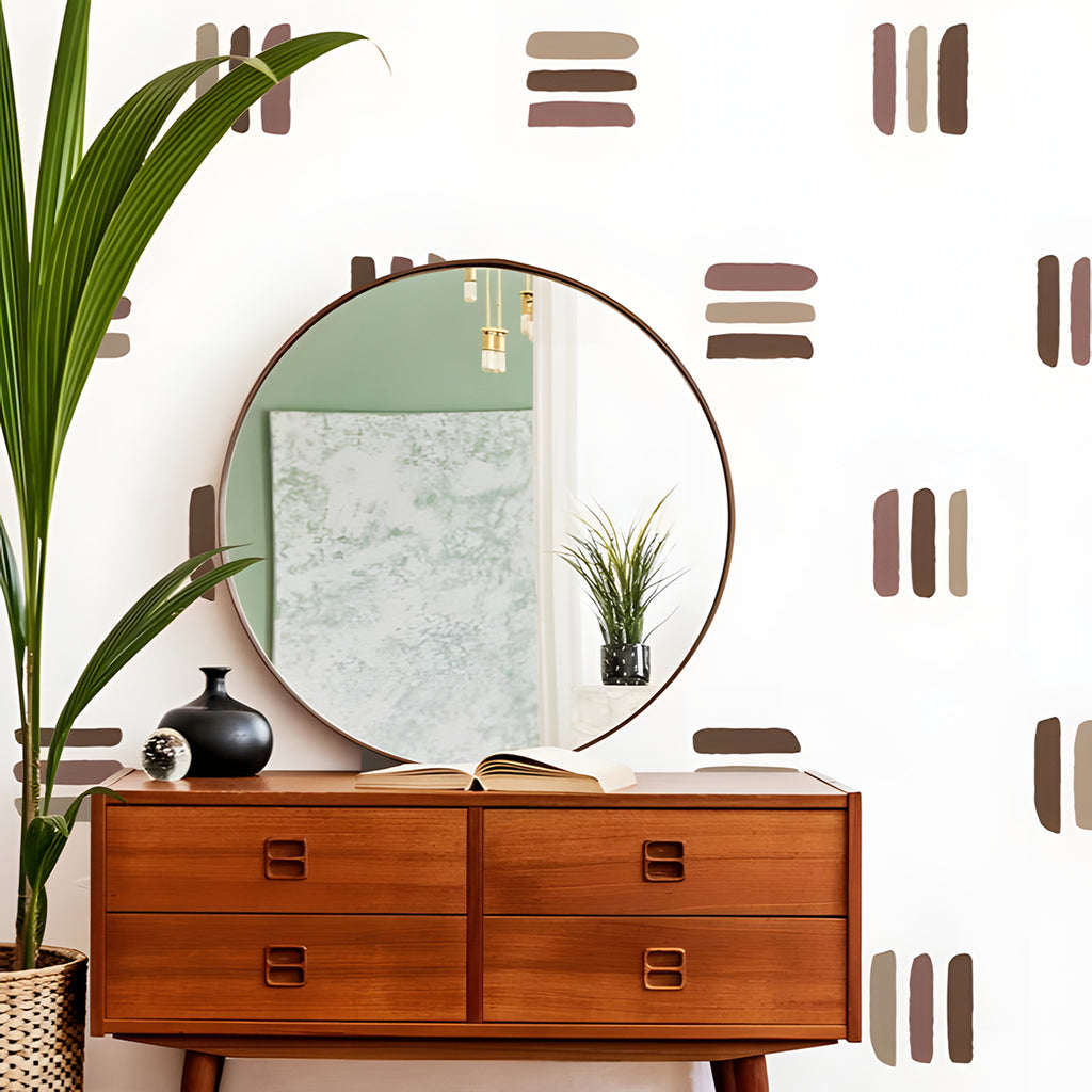 A stylish room with wooden mid-century furniture, including an open-drawer dresser displaying books. A round mirror hangs above, reflecting a potted plant. The walls feature muted old Lines, Wall Decals in Brown.