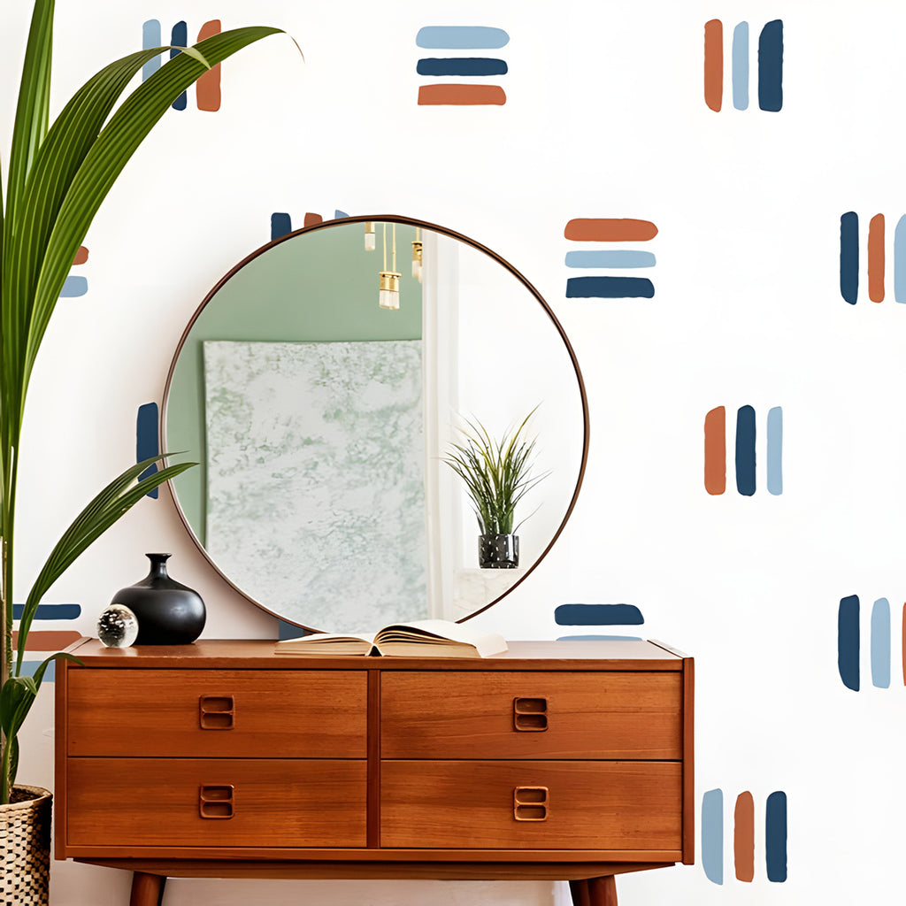 A stylish room with wooden mid-century furniture, including an open-drawer dresser displaying books. A round mirror hangs above, reflecting a potted plant. The walls feature muted old Lines, Wall Decals in Dark Blue-Light Blue-Orange Close Up