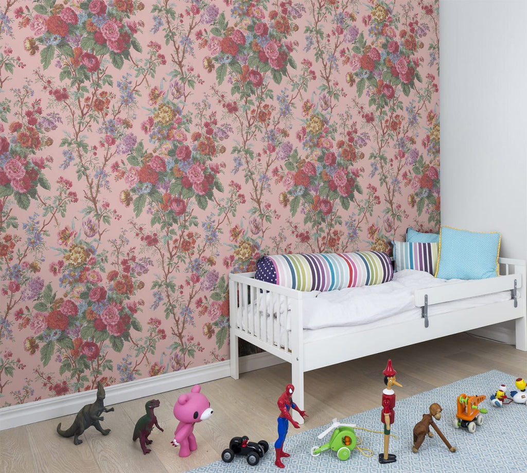 Bouquet Floral Pattern Wallpaper in Pink, featured on a wall of a kid’s bedroom with a mini sofa surrounded by toys and action figures