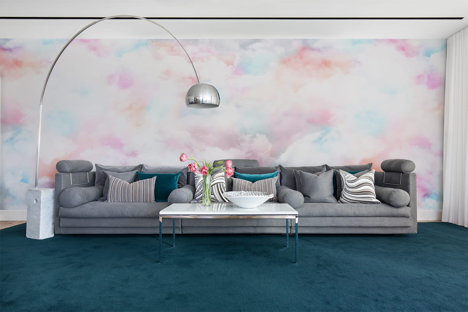Bubble Gum Clouds, Pastel Mural Wallpaper as seen on the wall of a living area with brown sofa, multiple pillows and a felt floor mat