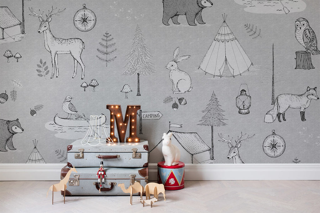 Camping Trip in Grey, Animal Pattern Wallpaper featured on a wall of kid’s playroom with stacked briefcase and and LED lights, surrounded by toys